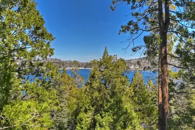 a view of a lake through the trees at Stunning LAKE VIEW Game Room Spa Walk To Village in Lake Arrowhead