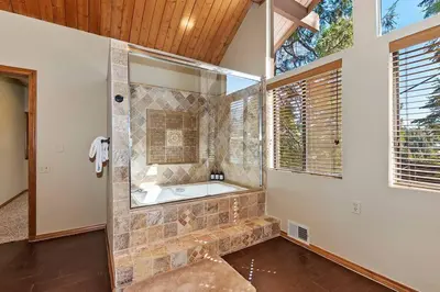 a large bathroom with a tub and a window at Stunning LAKE VIEW Game Room Spa Walk To Village in Lake Arrowhead