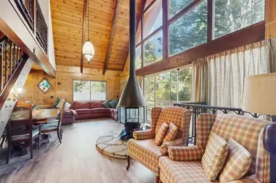 a living room with a couch and a fireplace at Retro Cabin in Lake Arrowhead