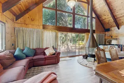 a living room with a couch and a fireplace at Retro Cabin in Lake Arrowhead