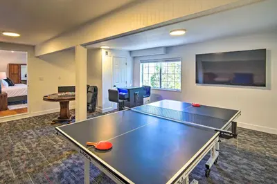 a ping pong table in a hotel room with a ping pongetitive at Ridgeline Retreat with Mountain Lake Views! in Lake Arrowhead