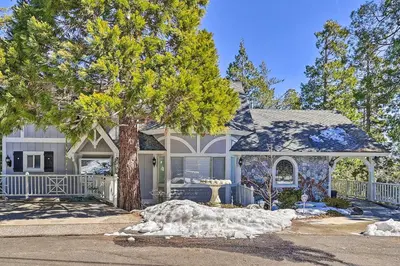 a house with a tree in front of it at Ridgeline Retreat with Mountain Lake Views! in Lake Arrowhead