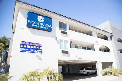 a building with a sign on the side of it at Pico Rivera Inn and Suites in Pico Rivera