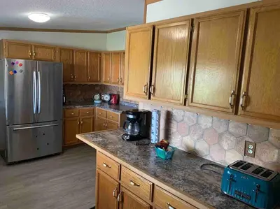 a kitchen with wooden cabinets and a stainless steel refrigerator at Views Views Views! in Wofford Heights