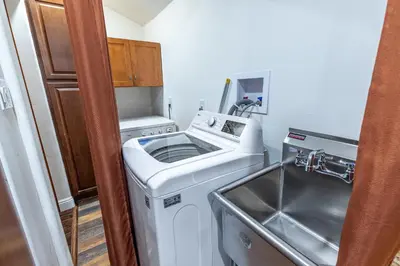 a washing machine in a kitchen with a sink at Spacious Home with Garden & Pool in Northridge