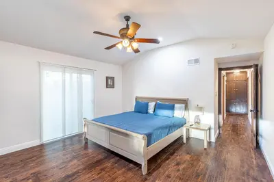 a bedroom with a bed and a ceiling fan at Spacious Home with Garden & Pool in Northridge