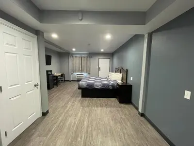 a bedroom with a bed and a hallway with a door at Cornett Motel in Los Angeles