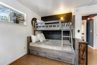 a bedroom with a bunk bed in a room at Blue Bird Beauty in Running Springs