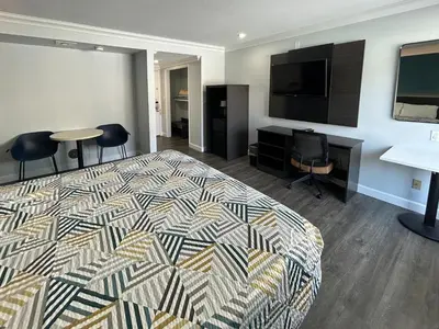 a hotel room with a bed and a flat screen tv at Motel 6 Buena Park, CA Anaheim Near Maingate Knotts in Buena Park