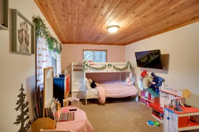 a bedroom with a bunk bed in a room at Peaceful and Idyllic Forest Cabin with Pool Table in Pine Mountain Club
