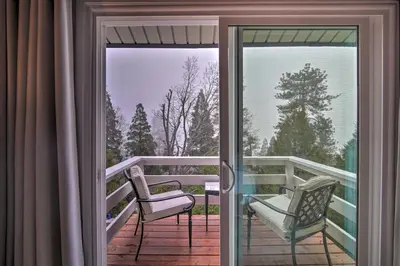 a balcony with two chairs and a sliding glass door at Picturesque Cabin 2 Balconies, Walk to Lake! in Crestline