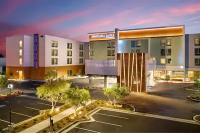 an empty parking lot in front of a building at SpringHill Suites by Marriott Los Angeles Downey in Downey