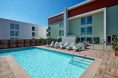 a swimming pool in front of a hotel at SpringHill Suites by Marriott Los Angeles Downey in Downey