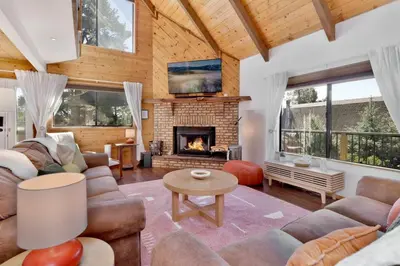 a living room with a couch and a fireplace at Chimney Peak Chalet #2048 by Big Bear Vacations in Big Bear City