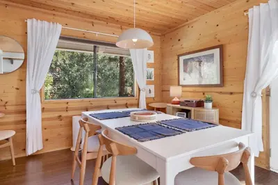 a dining room with a white table and chairs at Chimney Peak Chalet #2048 by Big Bear Vacations in Big Bear City