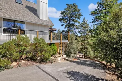 a house with a balcony and a driveway at Chimney Peak Chalet #2048 by Big Bear Vacations in Big Bear City