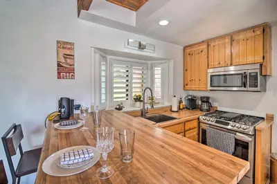 a kitchen with a wooden counter top and wooden cabinets at Crestline Cabin with Deck 1 Mi to Lake Gregory in Crestline