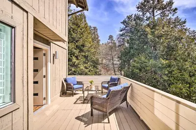 a deck with chairs and a table on a house at Crestline Cabin with Deck 1 Mi to Lake Gregory in Crestline