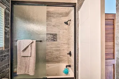 a bathroom with a shower with a glass door at Crestline Cabin with Deck 1 Mi to Lake Gregory in Crestline