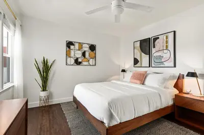 a white bedroom with a large bed and a window at Spacious Coastal Apartment in a Colorful Community - NRP22-00590 in Long Beach