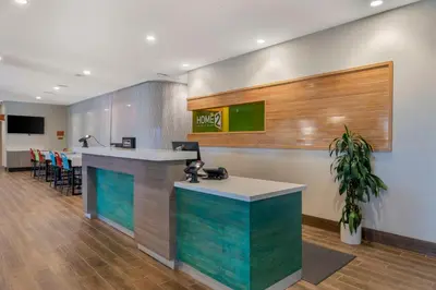 an office lobby with a counter and a bar at Home2 Suites By Hilton Redlands in Redlands