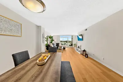 a living room with a table with a bowl of fruit on it at The tulip Marina Highrise with ocean view in Los Angeles