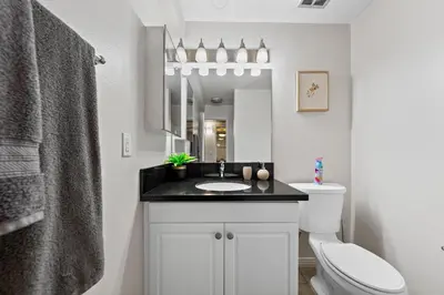 a bathroom with a sink and a toilet and a mirror at The tulip Marina Highrise with ocean view in Los Angeles
