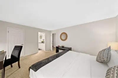 a bedroom with a large white bed and a desk at The tulip Marina Highrise with ocean view in Los Angeles