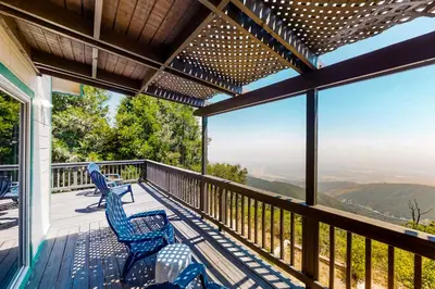a balcony with chairs and a view of the mountains at Million Dollar Mountain View in Crestline