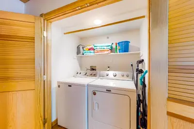 a small laundry room with a washer and dryer at Million Dollar Mountain View in Crestline