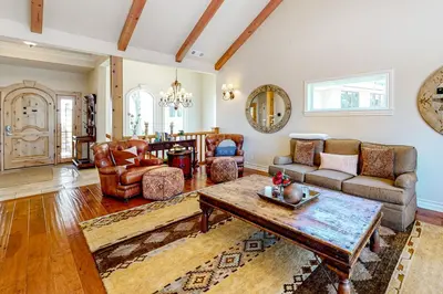 a living room with a couch and a table at Bayfront Beauty in Lake Arrowhead