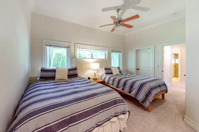 a bedroom with two beds and a ceiling fan at Bayfront Beauty in Lake Arrowhead