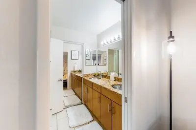 a bathroom with two sinks and a large mirror at Pacific Cove Unit 111 in Los Angeles