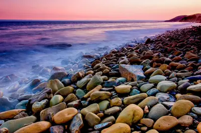 a group of rocks on the beach at sunset at Sailaway Cabin A in Ventura