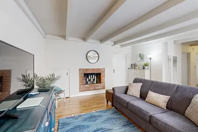 a living room with a couch and a fireplace at Sailaway Cabin A in Ventura