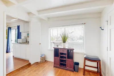 a kitchen with a table and a chair in a room at Sailaway Cabin B in Ventura