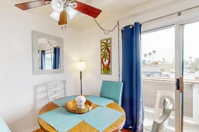 a dining room with a table and a window at Sailaway Cabin B in Ventura