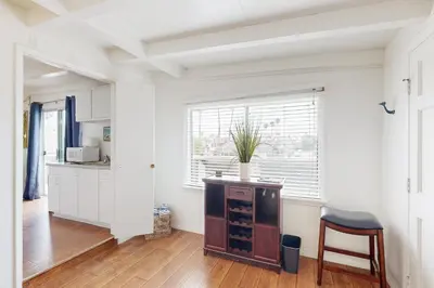 a kitchen with a table and a chair in a room at Sailaway Cabin in Ventura