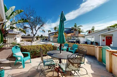 a patio with a table and chairs and a umbrella at Bangor Lane Oasis in Ventura