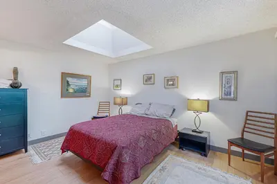a bedroom with a bed and two chairs at Gateshead Haven in Oxnard