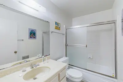 a white bathroom with a sink and a toilet at Gateshead Haven in Oxnard