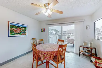 a dining room with a table and chairs and a ceiling fan at Gateshead Haven in Oxnard