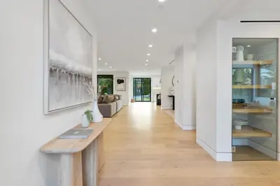 a hallway with a wooden bench in a house at Curson Modern in Los Angeles