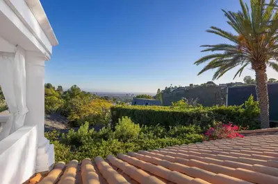 a view from the roof of a house with a palm tree at Stradella Spanish in Los Angeles