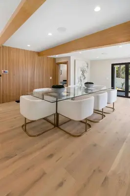 a dining room with a glass table and white chairs at Sea Vista in Malibu