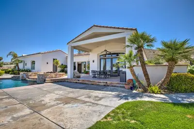 a house with a swimming pool and palm trees at Stunning Palmdale Villa Oasis on Vineyard! in Palmdale
