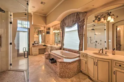 a bathroom with a tub and a sink and a shower at Stunning Palmdale Villa Oasis on Vineyard! in Palmdale