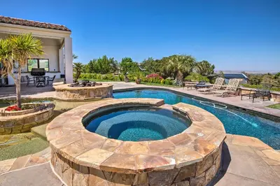 an outdoor swimming pool with a fire pit and a patio at Stunning Palmdale Villa Oasis on Vineyard! in Palmdale