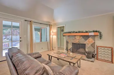 a living room with a couch and a fireplace at Cozy Skyforest Cabin about 1 Mi to Lake Arrowhead! in Skyforest