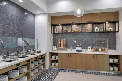 a kitchen with a counter with plates and dishes at Residence Inn by Marriott Chatsworth in Chatsworth
